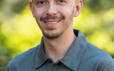 Smiling man with short hair